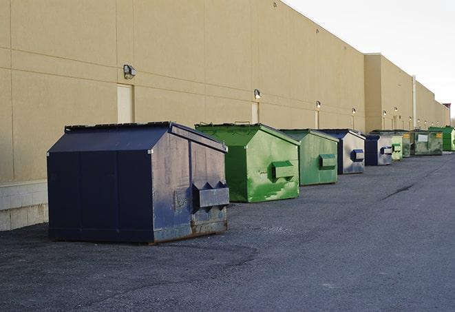 a fleet of red and blue construction dumpsters available for use in Bethany